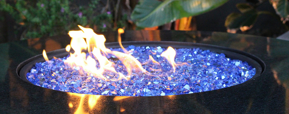 reflective blue fire glass in outdoor fire pit