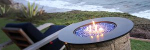 picture of cobalt blue reflective fire glass fire pit on the beach